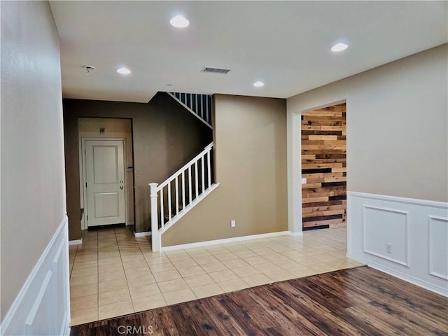 interior space featuring wood walls and light hardwood / wood-style floors