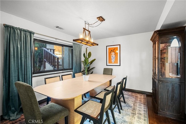 dining space with dark hardwood / wood-style flooring