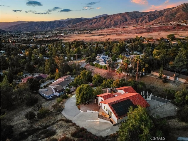 aerial view at dusk featuring a mountain view