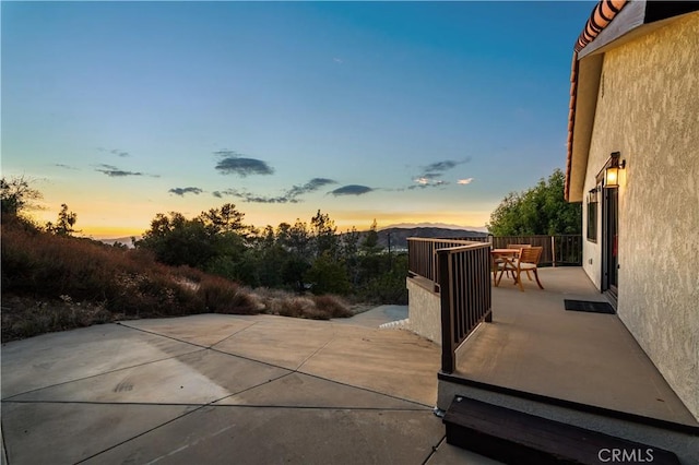 view of patio terrace at dusk