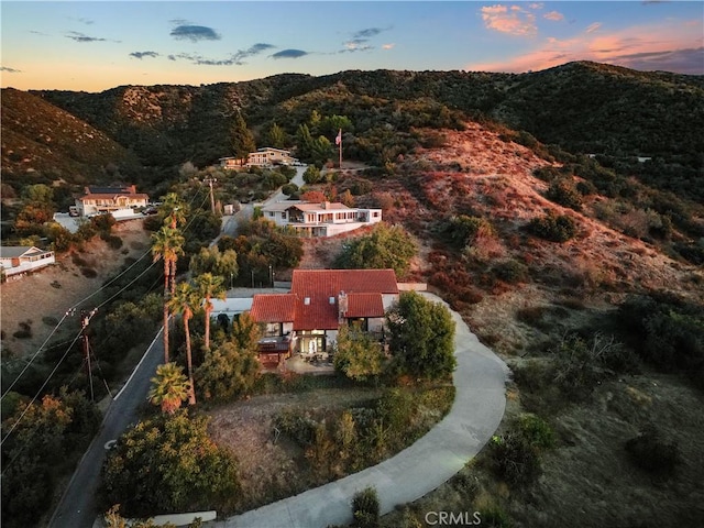 aerial view at dusk featuring a mountain view