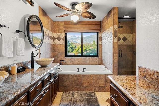 bathroom featuring vanity, ceiling fan, and independent shower and bath