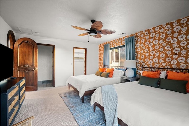 bedroom featuring ceiling fan, light colored carpet, a spacious closet, and a closet