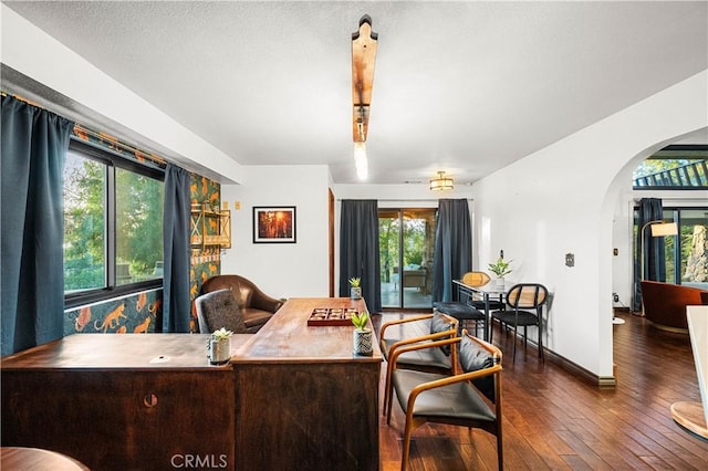 interior space featuring plenty of natural light and dark hardwood / wood-style floors