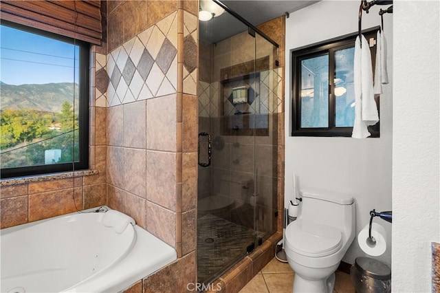 bathroom with tile patterned floors, a mountain view, plus walk in shower, and a wealth of natural light