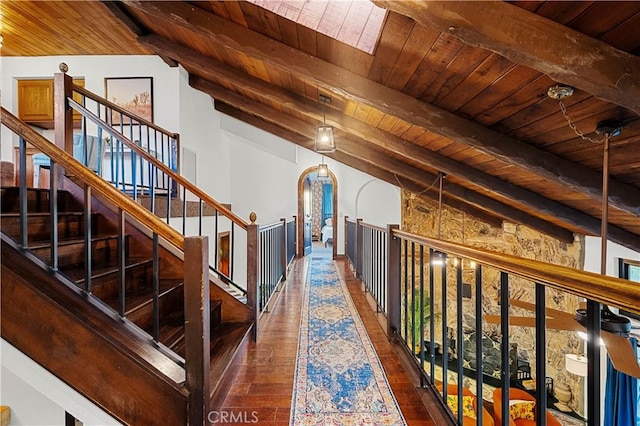 hall featuring beamed ceiling, dark hardwood / wood-style flooring, wood ceiling, and high vaulted ceiling