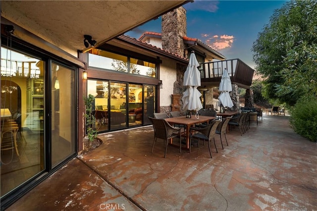 patio terrace at dusk with a balcony