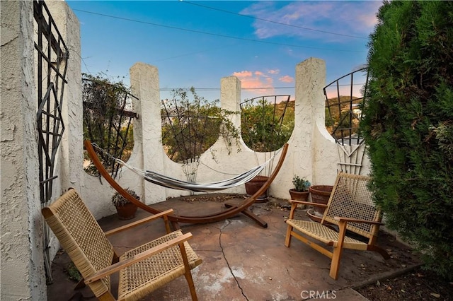 view of patio terrace at dusk