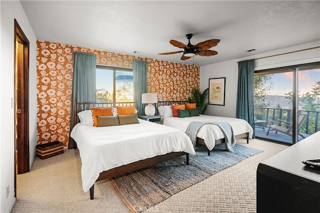 bedroom with access to outside, ceiling fan, and light carpet