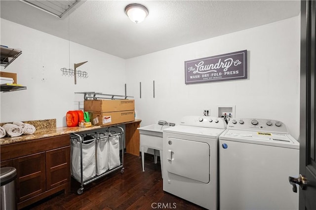 clothes washing area with washer and dryer, dark hardwood / wood-style flooring, and a textured ceiling