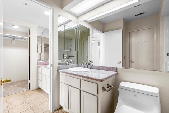 bathroom featuring tile patterned floors, vanity, and toilet