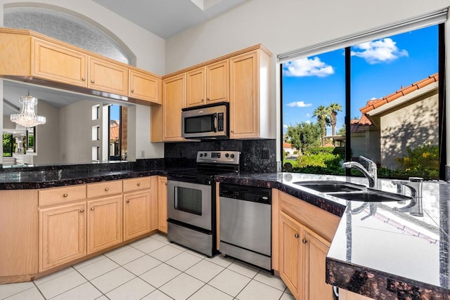 kitchen with pendant lighting, stainless steel appliances, plenty of natural light, and sink