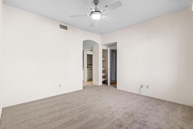 unfurnished room featuring light carpet and ceiling fan