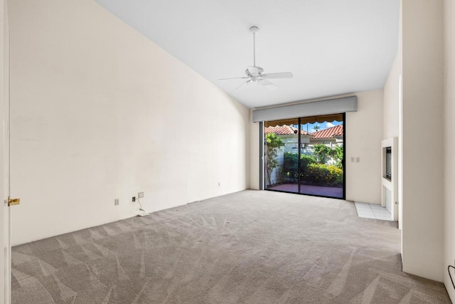 spare room featuring light colored carpet, baseboard heating, and ceiling fan