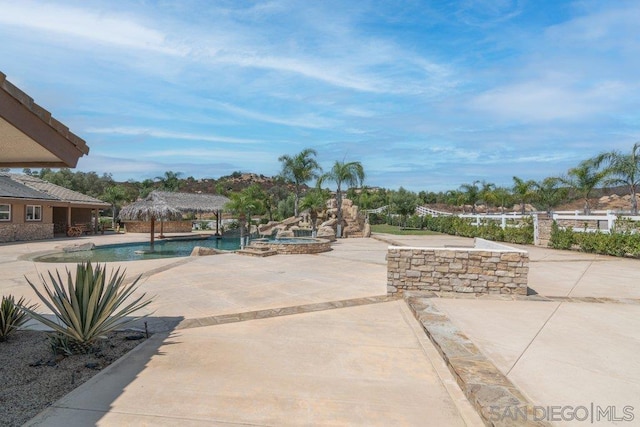 view of swimming pool featuring an in ground hot tub, a gazebo, and a patio area