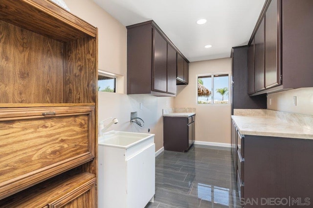 kitchen featuring dark brown cabinetry and sink