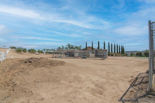 view of yard with a rural view and an outdoor structure