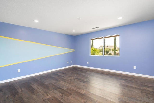 empty room with dark wood-type flooring