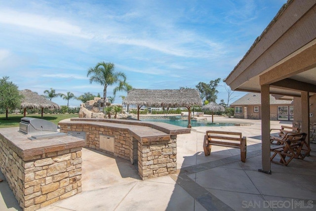 view of patio featuring a gazebo, area for grilling, and exterior kitchen