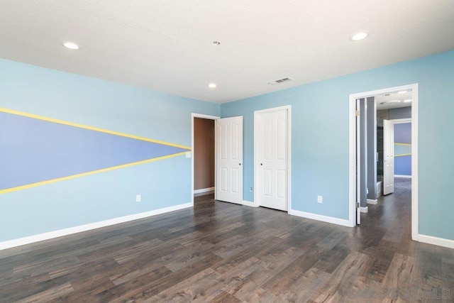 unfurnished bedroom featuring dark wood-type flooring