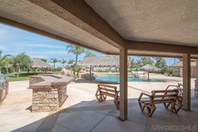 view of patio with a gazebo and an outdoor bar