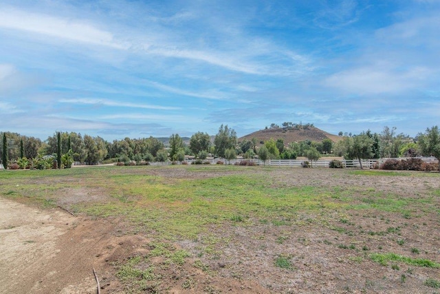 view of yard with a mountain view and a rural view