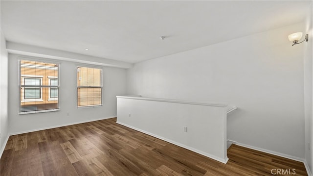 empty room featuring dark hardwood / wood-style flooring