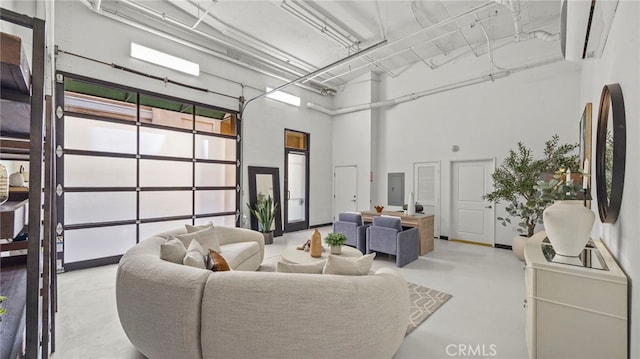 interior space with a towering ceiling and electric panel