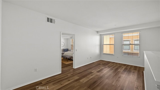 unfurnished room featuring dark wood-type flooring