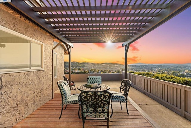 deck at dusk with a pergola