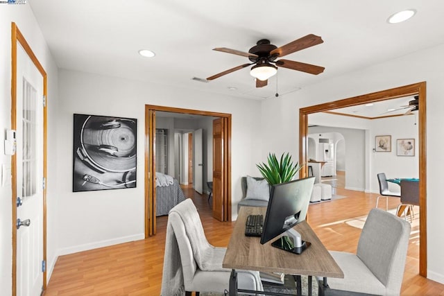 office area with ceiling fan and light hardwood / wood-style floors