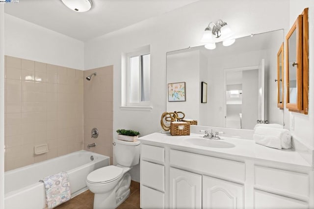 full bathroom with tile patterned flooring, vanity, toilet, and tiled shower / bath