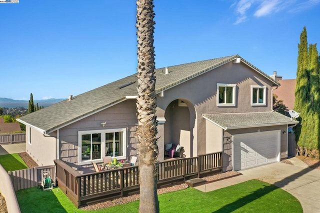 view of front of property with a garage and a front yard