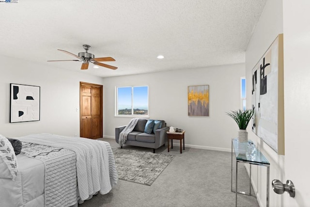 bedroom with light carpet, a textured ceiling, and ceiling fan