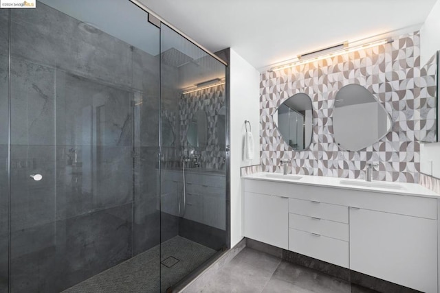 bathroom featuring a tile shower, vanity, and tasteful backsplash