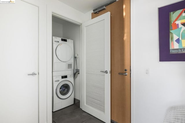 washroom with stacked washing maching and dryer