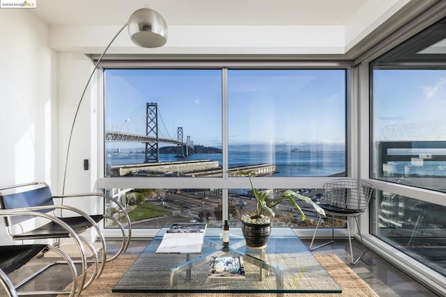 sunroom / solarium featuring a water view