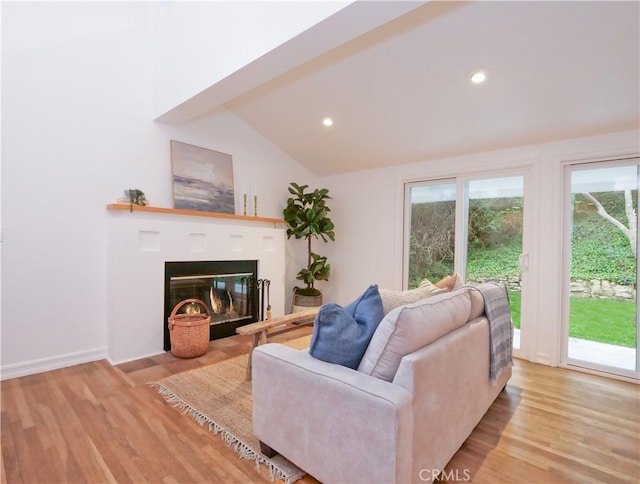 living room with light wood-type flooring and vaulted ceiling