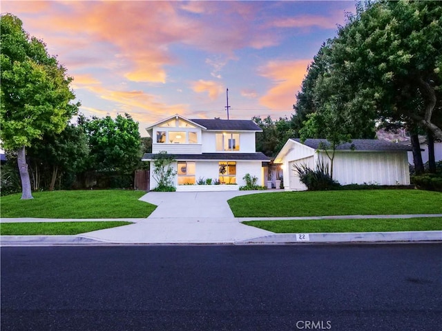 view of front of property featuring a garage and a yard