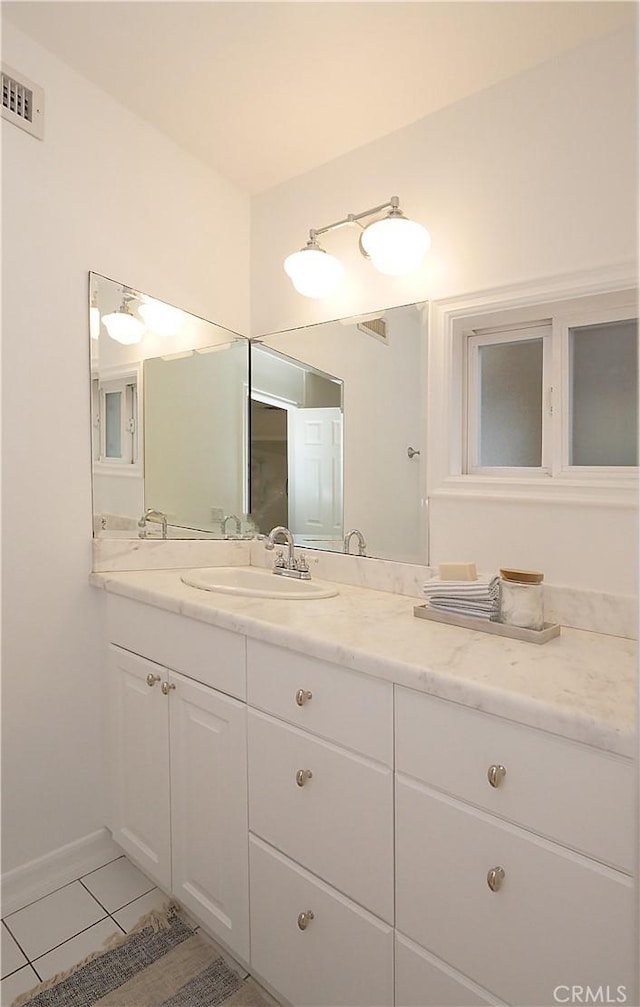 bathroom with tile patterned floors and vanity