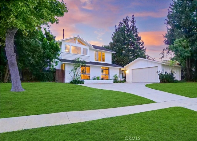 view of front of home featuring a lawn and a garage