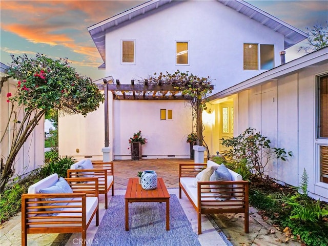 patio terrace at dusk with outdoor lounge area and a pergola