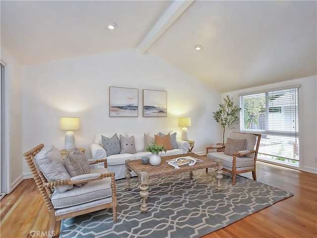 living room featuring wood-type flooring and lofted ceiling with beams