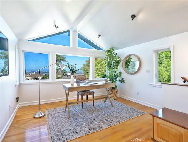 office space featuring vaulted ceiling with beams and hardwood / wood-style flooring