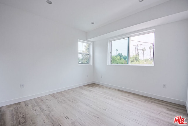 unfurnished room featuring light hardwood / wood-style floors