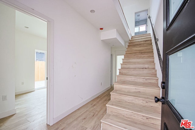 stairway featuring hardwood / wood-style floors