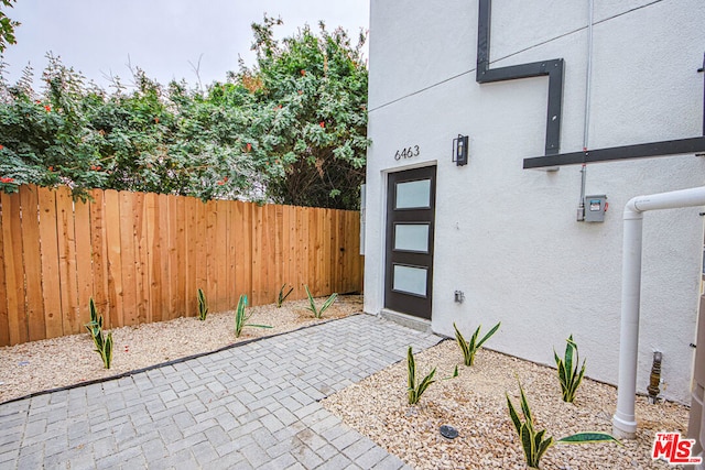 view of exterior entry featuring a patio