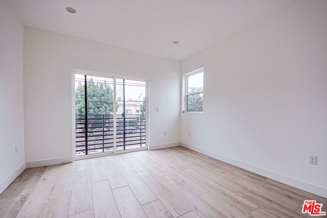 spare room with light hardwood / wood-style flooring