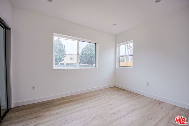 unfurnished room featuring light hardwood / wood-style floors