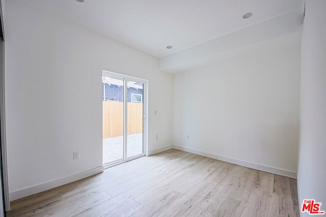 spare room featuring light hardwood / wood-style floors